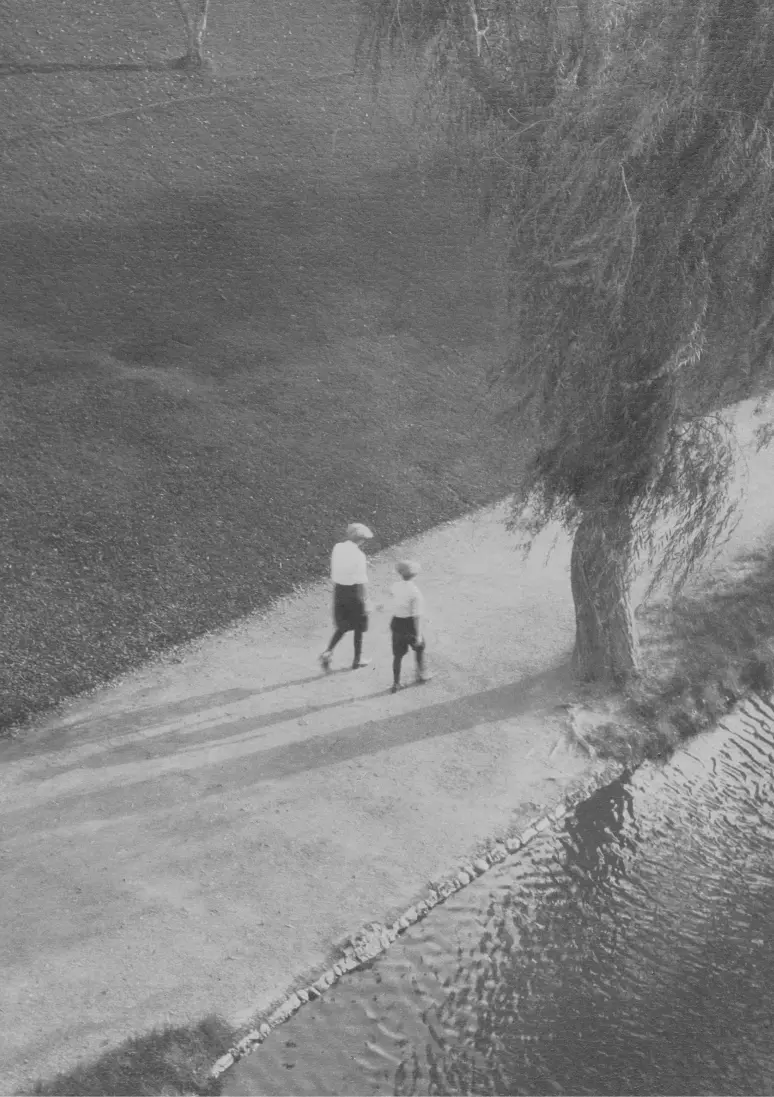 Black and white photo focusing on two boys from afar.